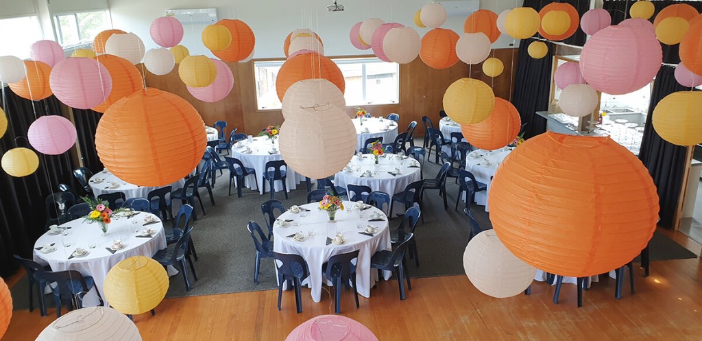 Hall set up with balloons and round tables